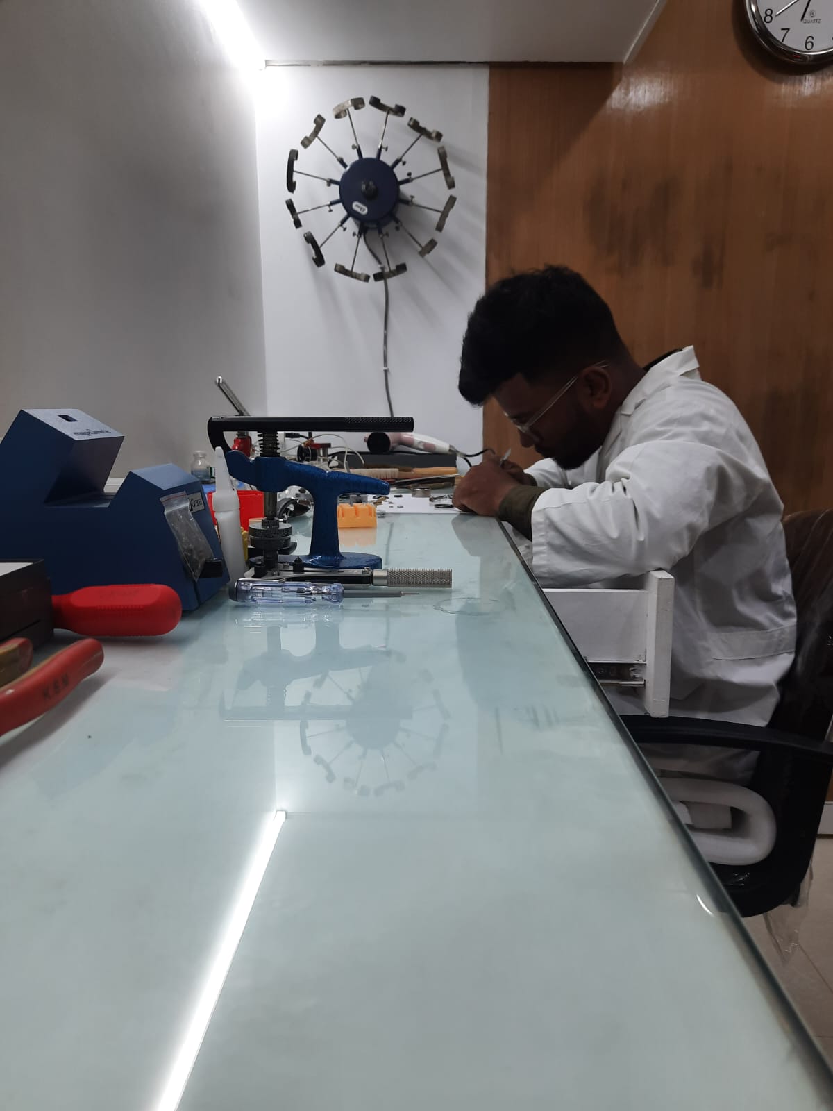A watch movement being assembled by a watchmaker.
